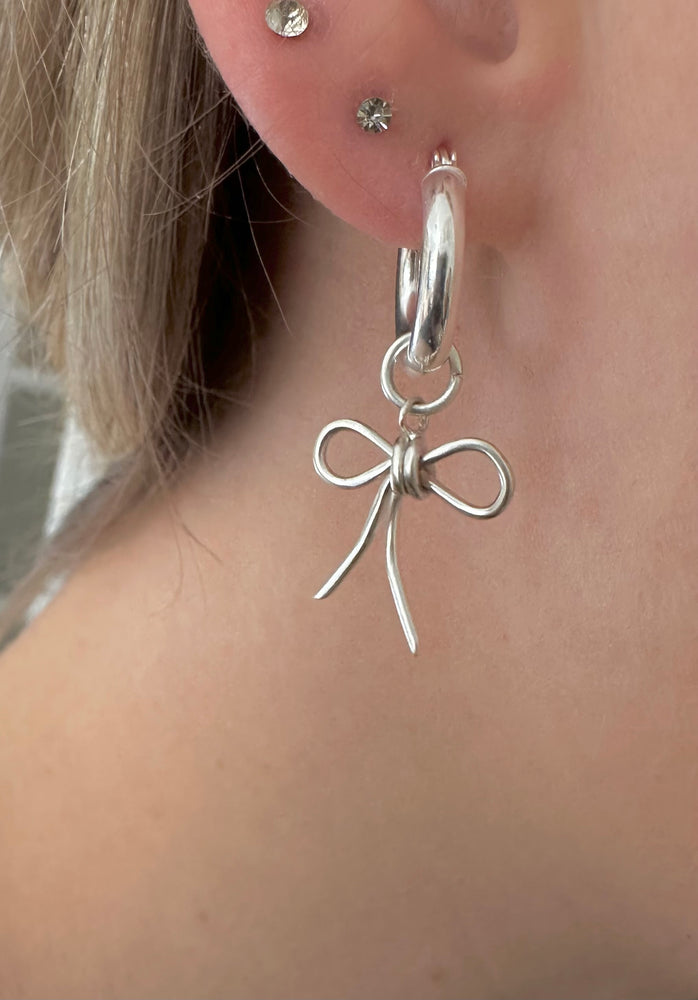 
                  
                    Sterling silver bow hoops
                  
                